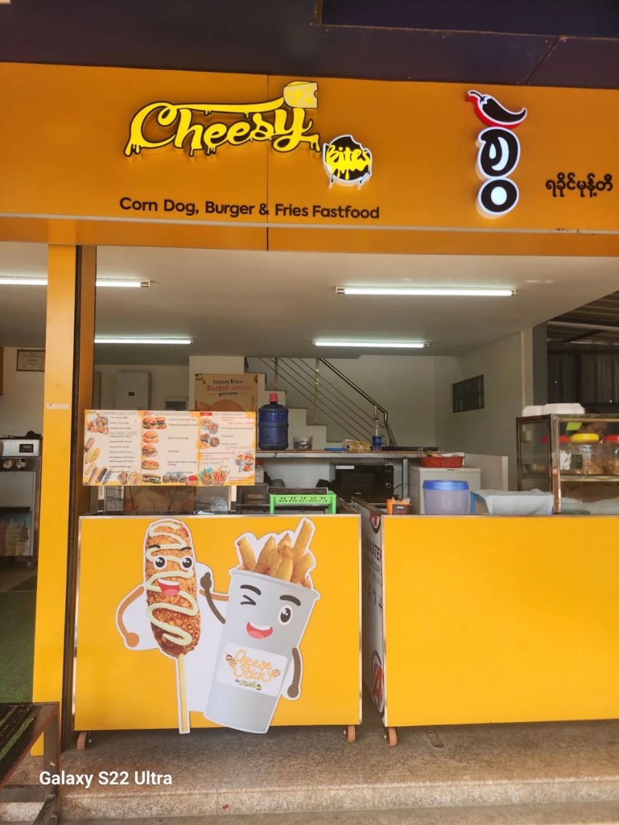 Cheesy Bites franchise shopfront with lit sign
